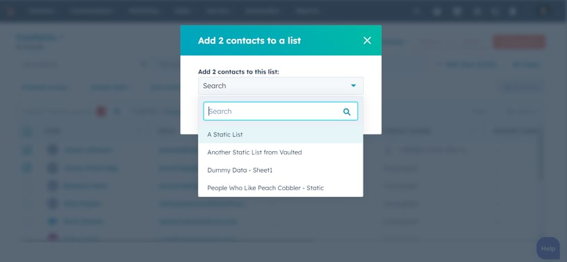 A screenshot of a dialog window in HubSpot, prompting the user to select a list for adding contacts. The window provides a dropdown menu with various list options, demonstrating the platform's user-friendly interface for contact management.