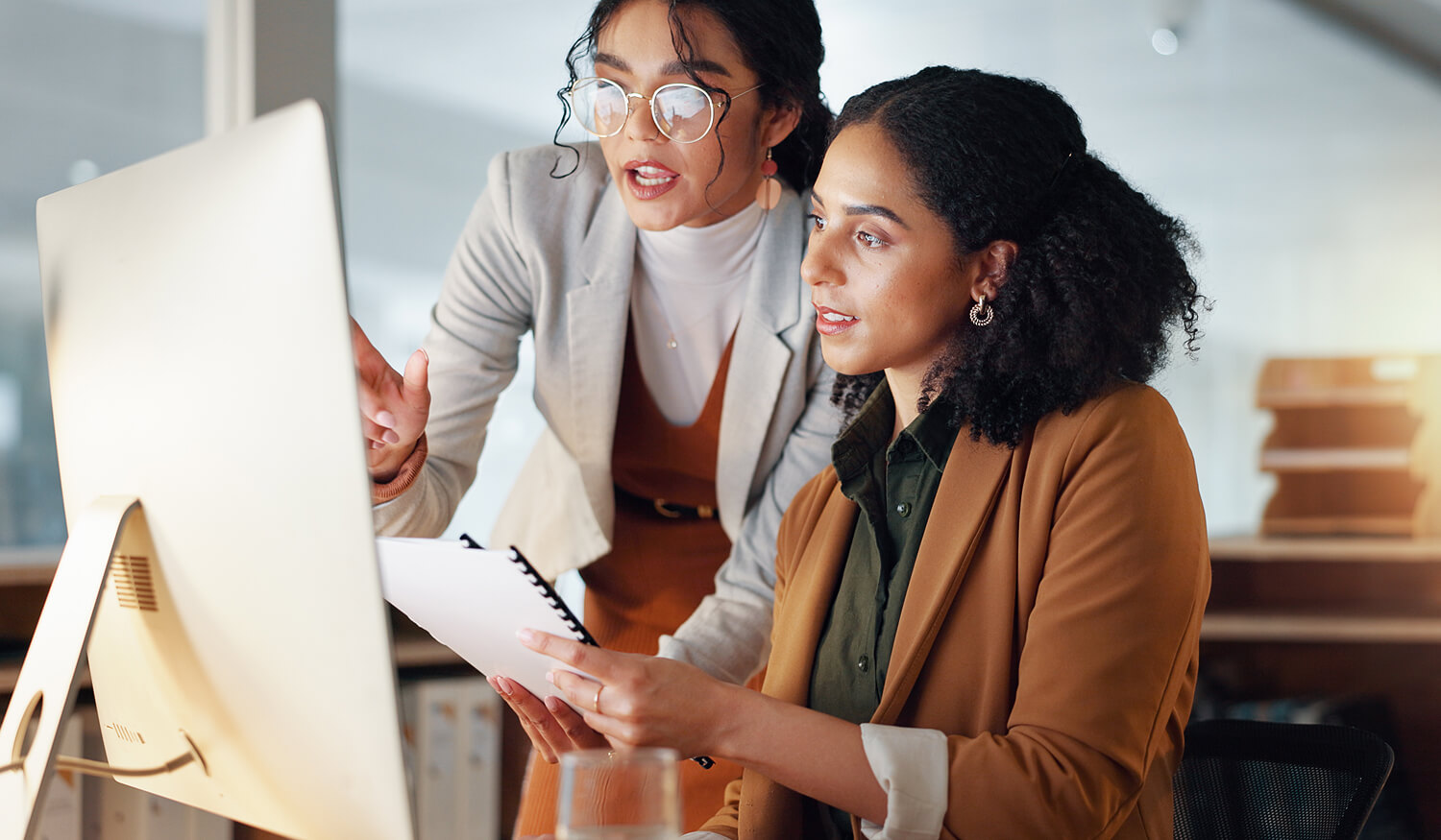 Two professionals evaluating HubSpot expert qualifications together at a computer