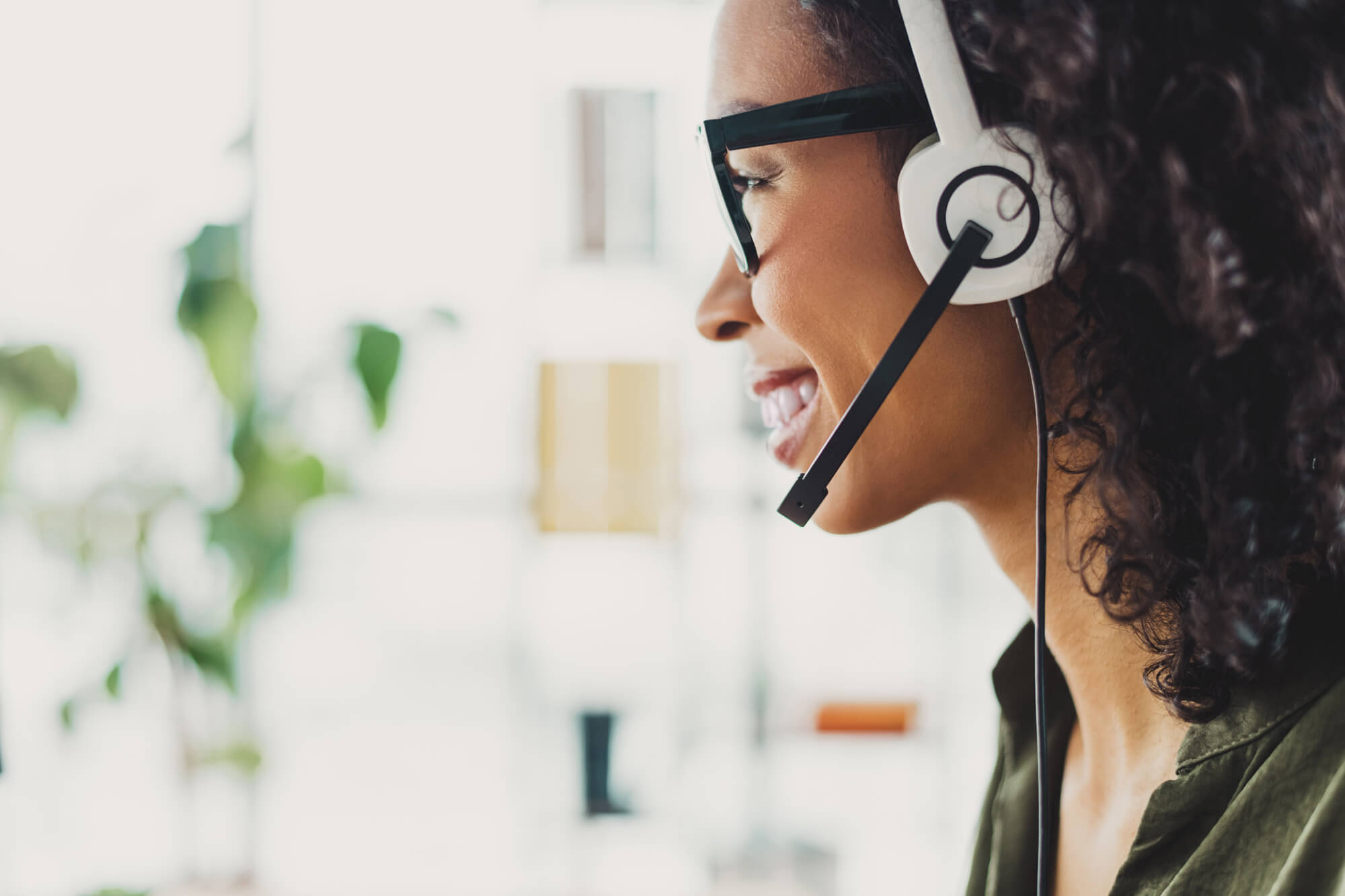 Customer service representative using a headset and CRM software, delivering personalized support with HubSpot’s ticketing system.