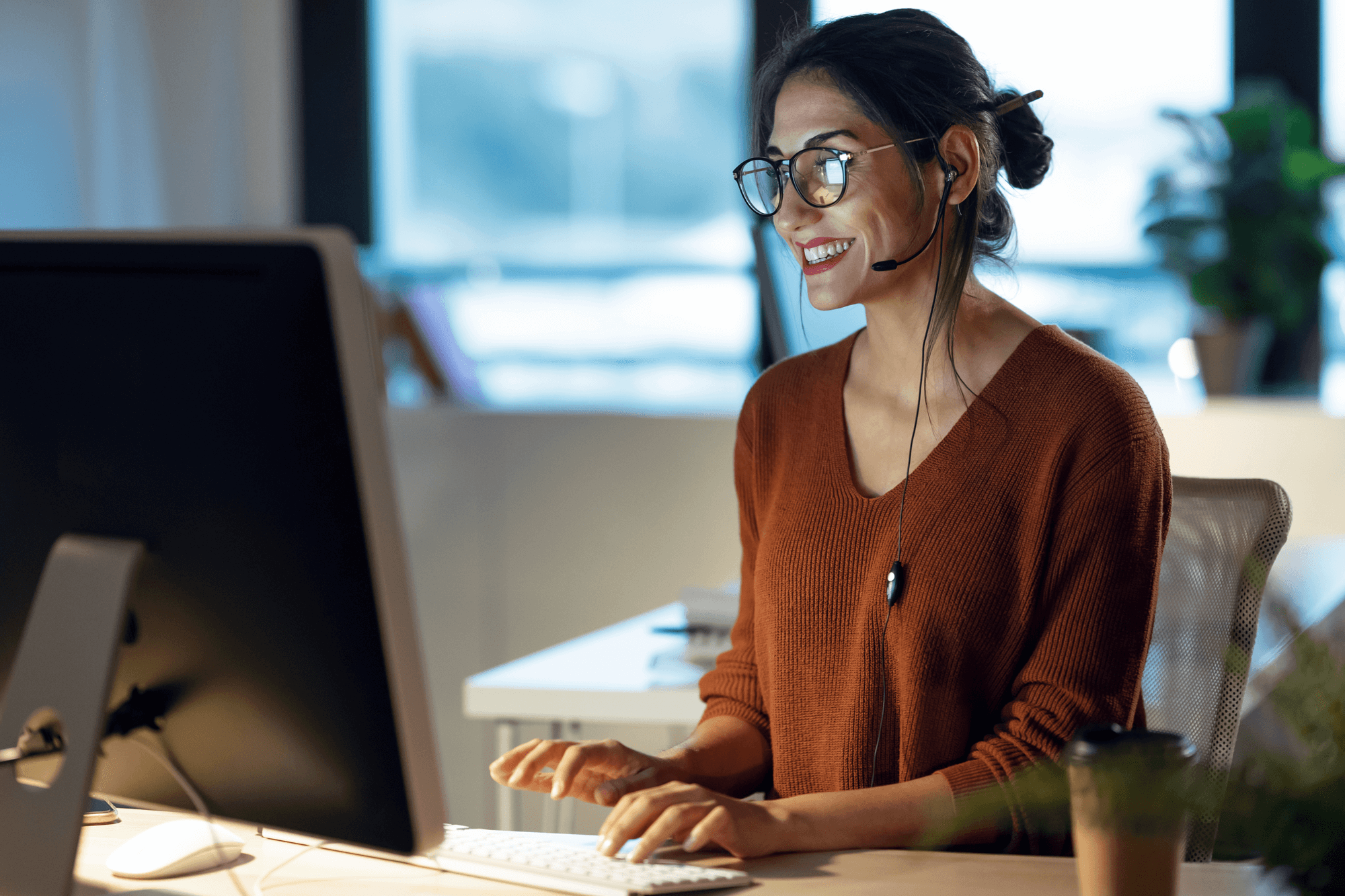 Marketing professional using HubSpot Marketing Hub on a desktop computer to manage digital campaigns and customer communications
