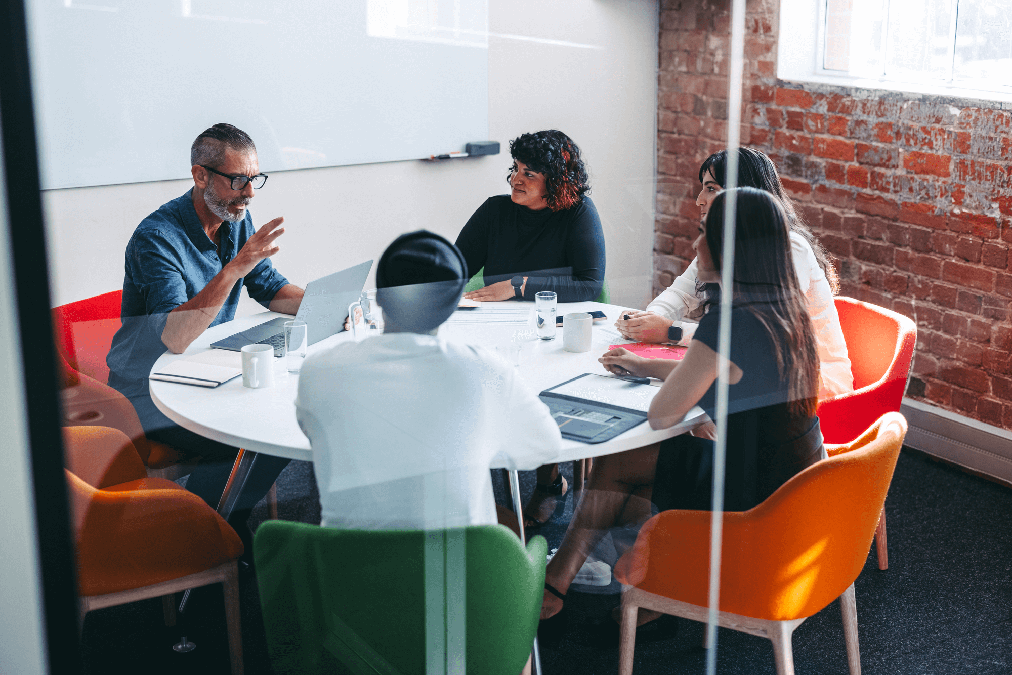 Business team in a Raleigh meeting room aligning on growth strategy — representing how local SEO helps brands connect with nearby customers and outperform local competition.