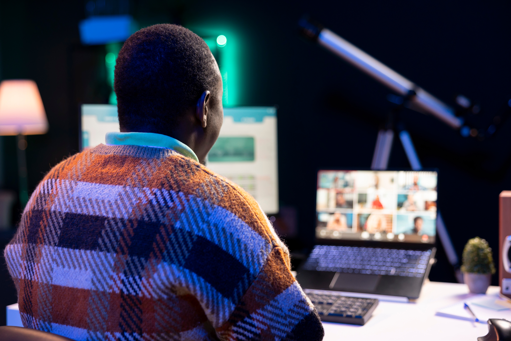 Person working at a computer setup during a video conference call, highlighting the importance of ongoing SEO strategies and adapting to market changes