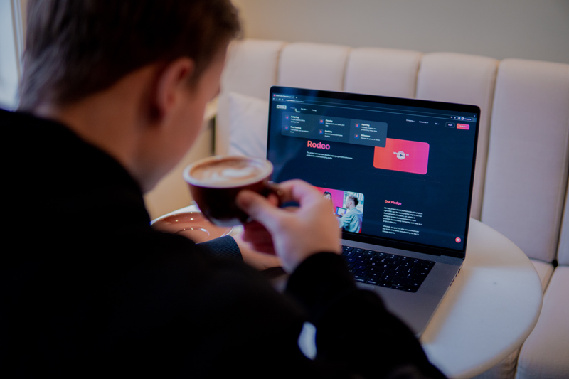 Designer working at a desk with a large monitor, reviewing a website layout—showcasing the creative process behind a visually appealing HubSpot website.